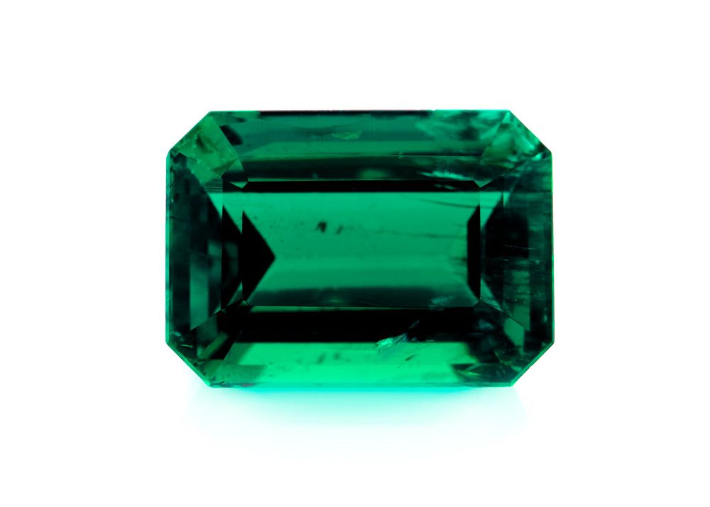 large dark green Ethiopian emerald stone on a white background