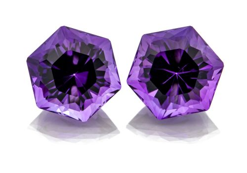 A pair of vibrant purple hexagon shaped Amethyst